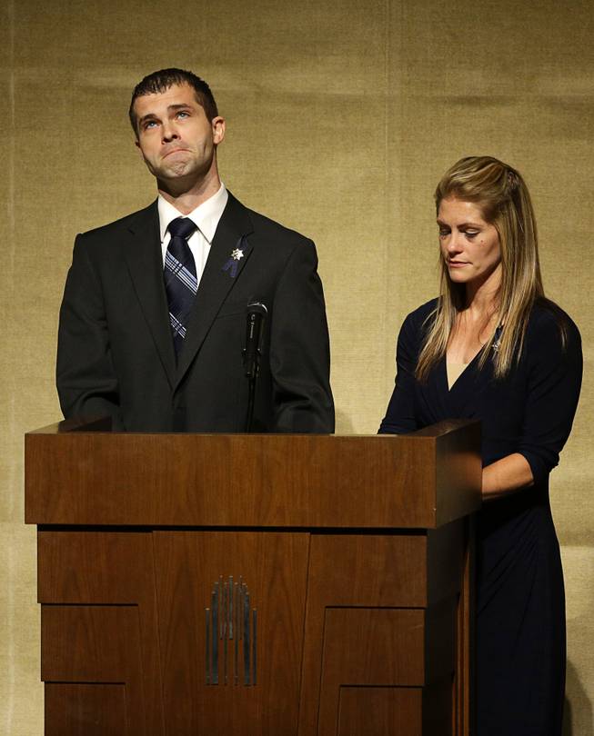 Joseph Beck, left, and Elizabeth Krmpotich speak during a memorial service for their brother Las Vegas Metropolitan Police Officer Alyn Beck at The Smith Center for the Performing Arts Saturday, June 14, 2014 in Las Vegas. Two suspects shot and killed Beck, 41, and fellow police officer Igor Soldo, 31, in an ambush at a Las Vegas restaurant Sunday, June 8, 2014, before fatally shooting a third person inside a nearby Wal-Mart, authorities said.