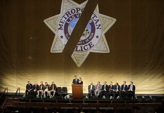 Joseph Beck, center left, and Elizabeth Krmpotich speak during a memorial service for their brother Las Vegas Metropolitan Police Officer Alyn Beck at The Smith Center for the Performing Arts Saturday, June 14, 2014 in Las Vegas. Two suspects shot and killed Beck, 41, and fellow police officer Igor Soldo, 31, in an ambush at a Las Vegas restaurant Sunday, June 8, 2014, before fatally shooting a third person inside a nearby Wal-Mart, authorities said.
