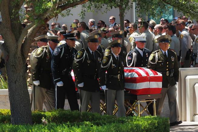 Pallbearers carry the coffin of Metro officer Alyn Beck during a memorial service Saturday, June 14, 2014 at the Smith Center for the Performing Arts.