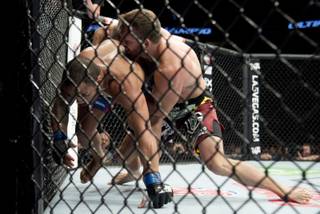Ryan Bader, right, of the United States, puts Rafael Cavalcante, of Brazil, against the cage during a light heavyweight bout at UFC 174 in Vancouver, British Columbia, Saturday, June, 14, 2014. (AP Photo/The Canadian Press, Jonathan Hayward)