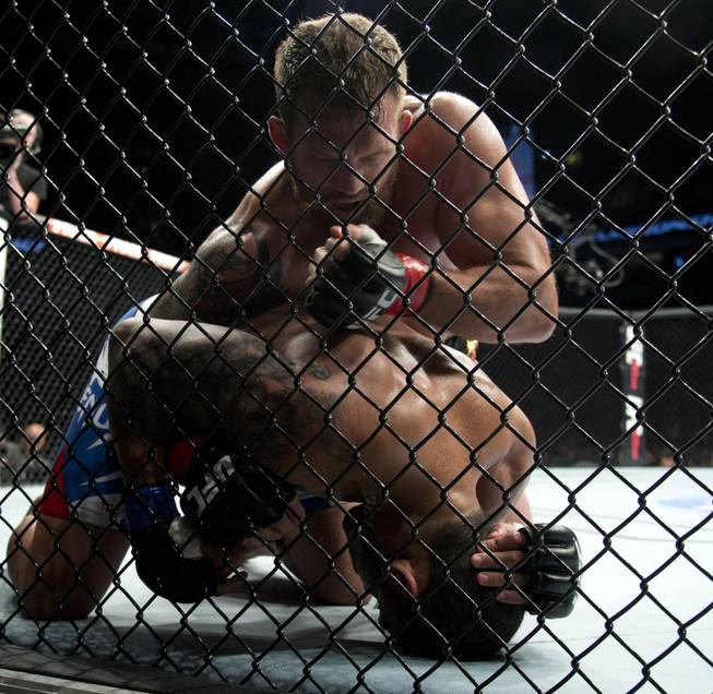 Ryan Bader, of the United States, puts Rafael Cavalcante, of Brazil, to the mat during a light heavyweight bout at UFC 174 in Vancouver, British Columbia, Saturday, June, 14, 2014. (AP Photo/The Canadian Press, Jonathan Hayward)