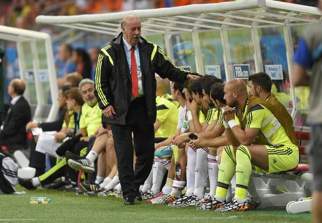 Spain's head coach Vicente Del Bosque greets his bench players during the group B World Cup soccer match between Spain and the Netherlands at the Arena Ponte Nova in Salvador, Brazil, Friday, June 13, 2014. The Netherlands won the match 5-1.