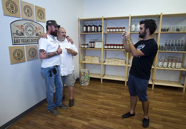 Steve Brockman takes a photo of Joseph Zecher, left, and Las Vegas Distillery owner George Racz during "Bourbon Day" at the distillery in Henderson Saturday, June 14, 2014. The "Nevada 150" bourbon whiskey, the first bourbon produced in Nevada, is named for Nevada's sesquicentennial.