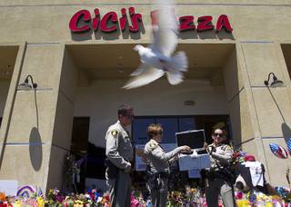 Metro Police officers Ion Iliescu, Lourdes Smith and  Michelle Wilson release two white doves during 