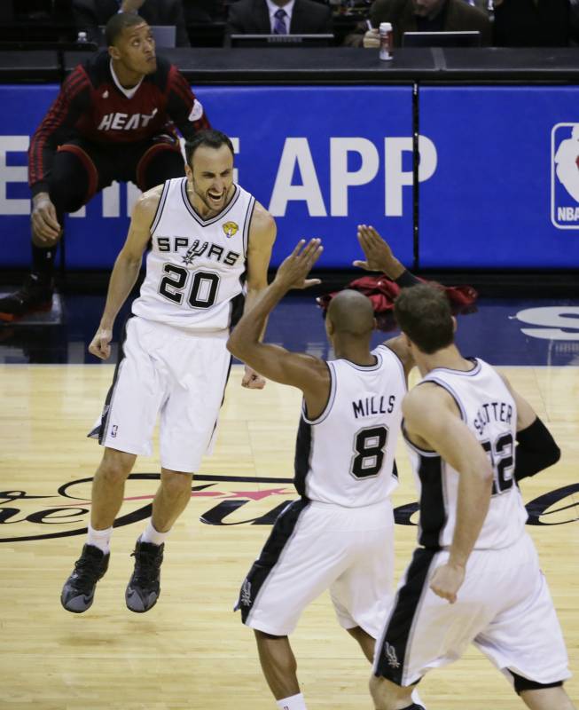 San Antonio Spurs guard Manu Ginobili (20), guard Patty Mills (8) and center Tiago Splitter (22) celebrate against the Miami Heat during the second half in Game 5 of the NBA basketball finals on Sunday, June 15, 2014, in San Antonio. (AP Photo/