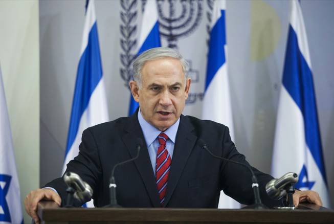 Israeli Prime Minister Benjamin Netanyahu speaks to the media in Tel Aviv, Israel, Sunday, June 15, 2014. Netanyahu has condemned Palestinian President Mahmoud Abbas' agreement with the militant group, and said he would hold him responsible for the safety of the youths, who disappeared apparently while hitchhiking in the West Bank late Thursday.
