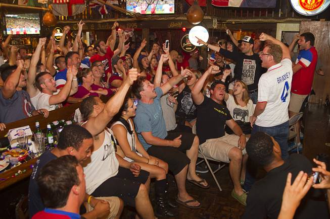 Aaron Kemper, right, leads fans in a chant as they watch the United States beat Ghana 2-1 in the World Cup during a viewing party at the Crown & Anchor British Pub Monday, June 16, 2014.