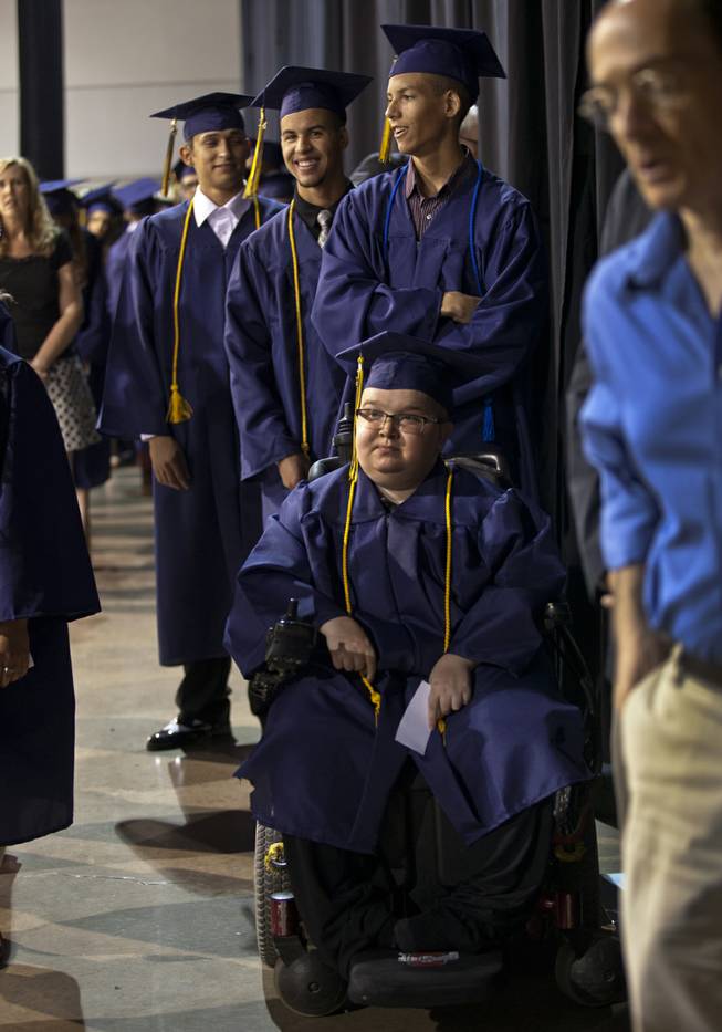 Lifelong friends Colton Shrum, Darius Martin and D'Aron Martin line up with other students at the Cashman Center  for their Odyssey Charter School graduation on Tuesday, June, 3, 2014.