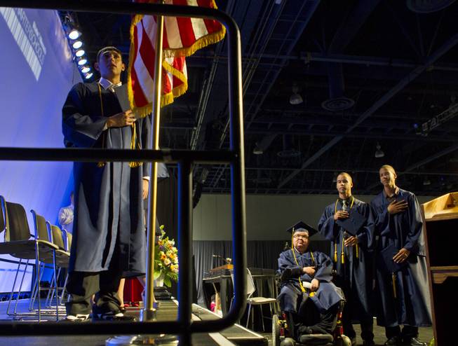 Colton Shrum, D'Aron Martin and Darius Martin recite the Pledge of Allegence with other students at the Cashman Center  for their Odyssey Charter School graduation on Tuesday, June, 3, 2014.