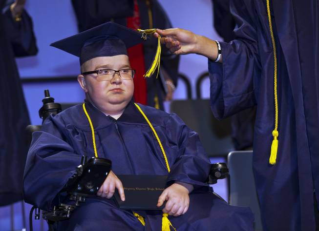 Colton Shrum has his tassel moved across by D'Aron Martin during their Odyssey Charter School graduation at the Cashman Center on Tuesday, June, 3, 2014.