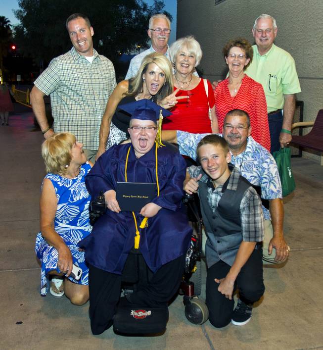 Colton Shrum and his family members share a fun moment following his Odyssey Charter School graduation at the Cashman Center on Tuesday, June, 3, 2014.