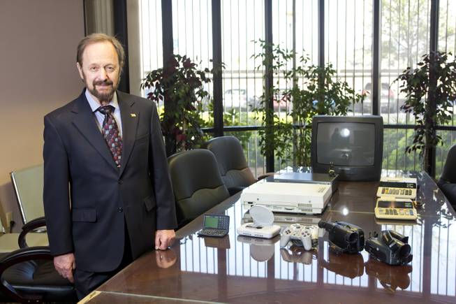 Gilbert Hyatt, local inventor and father of the micro-processor, stands by some of the various modern electronic devices that use his patented technologies Thursday April, 3, 2014