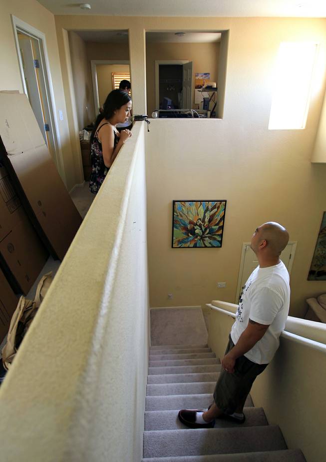 TSGT Rommel Delmundo, currently stationed at Nellis AFB, chats with his wife Rheina as the family packs for another military move Monday, June 16, 2014.