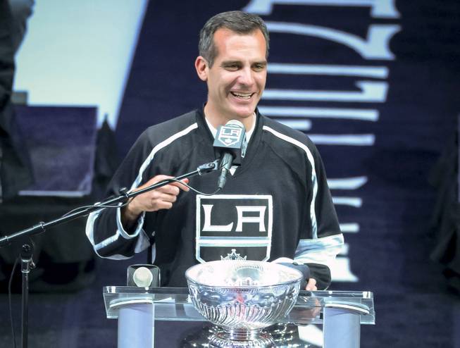 In this photo taken on Monday, June 16, 2014, Los Angeles Mayor Eric Garcetti talks to the crowd during the Los Angeles King's Stanley Cup hockey championship rally at Staples Center in Los Angeles.