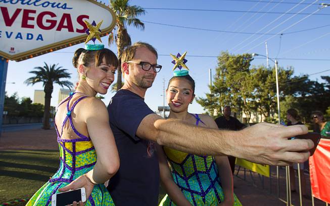 Dave Douglass of Los Angeles takes a selfie with Cossack Riders, Maria Maltseva and Albina Tanasheva of the Ringling Bros. and Barnum & Bailey Circus at the Welcome to Fabulous Las Vegas sign Wednesday, June 18, 2014. 