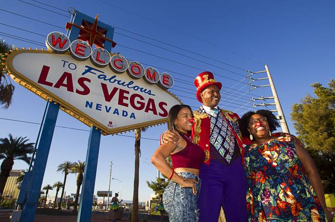 Ringling Bros. and Barnum & Bailey Circus Ringmaster Johnathan Lee Iverson poses with Lena Davis and Danielle Jones at the Welcome to Fabulous Las Vegas sign Wednesday, June 18, 2014. The circus performs at Thomas & Mack Center Thursday through Sunday.