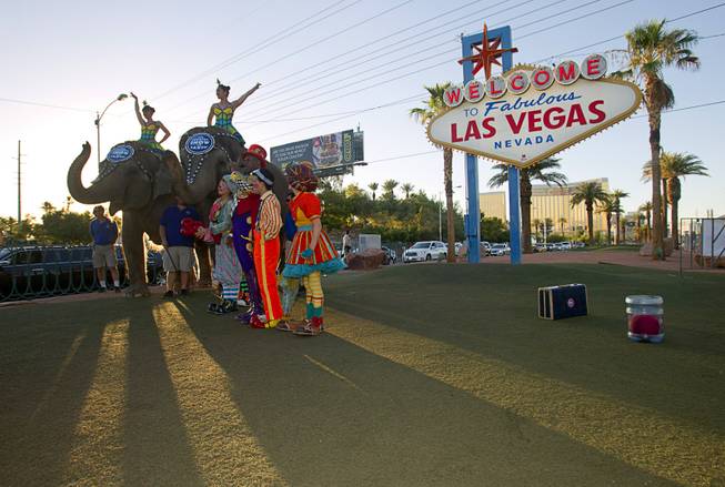 Members of Ringling Bros. and Barnum & Bailey Circus pose for photographs at the Welcome to Fabulous Las Vegas sign Wednesday, June 18, 2014. The circus performs at Thomas & Mack Center Thursday through Sunday.