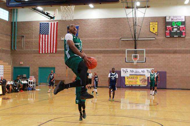 Former UNLV guard Kevin Olekaibe sails in for a fast break dunk during his Desert Reign basketball league game Wednesday, June 18, 2014.