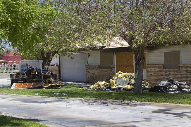 An exterior view of a home is shown after an early morning fatal fire near Ann Road and Durango Drive Thursday, June 19, 2014.  Two children, ages 2 and 4-years-old, died in the fire.