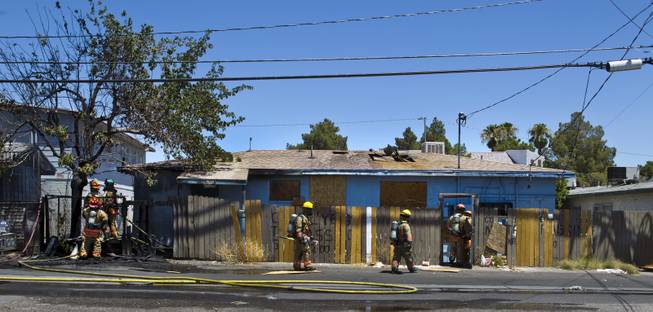 Las Vegas Fire & Rescue circle the property during an apartment fire at 1820 East Lewis Ave. which spread to a nearby tree and shed on Thursday, June, 19, 2014.