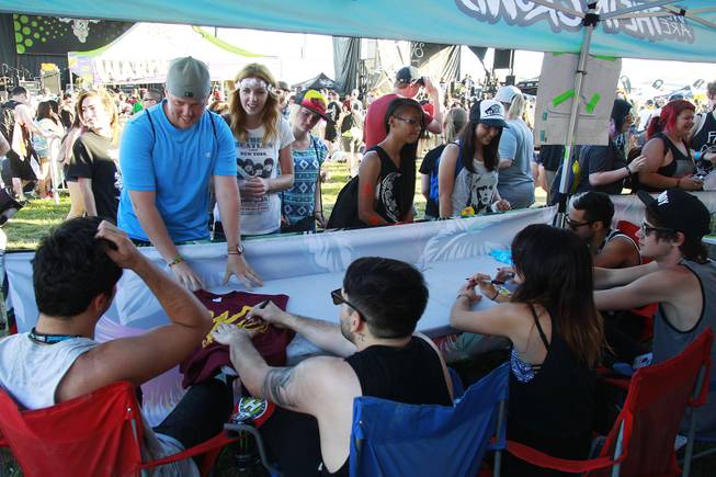 Fans line up for autographs with the band We Are the In Crowd during the Las Vegas stop of the Vans Warped Tour Thursday, June 19, 2014.