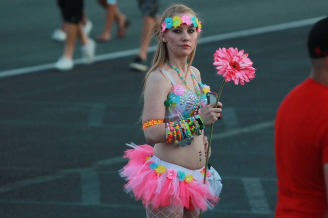 A young woman waits for a friend during the first night of the Electric Daisy Carnival Friday, June 20, 2014 at the Las Vegas Motor Speedway.