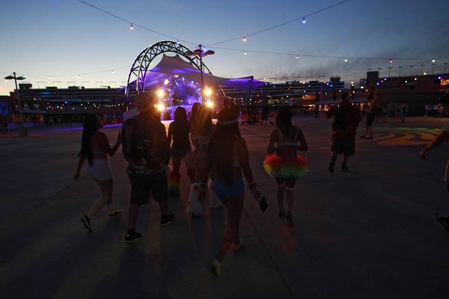 Attendees walk past the Discovery Stage during the first night of the Electric Daisy Carnival Friday, June 20, 2014 at the Las Vegas Motor Speedway.