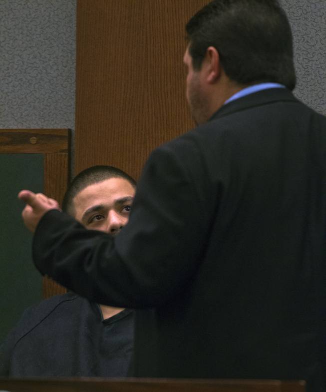 Adrian McClintock speaks to his attorney during his preliminary hearing at the Justice Center with Julio Renteria on Friday, June 20, 2014. The two are suspects in a Boulder Highway carjacking gone awry that ended in Dylan Joshua Salazar's fatal shooting.