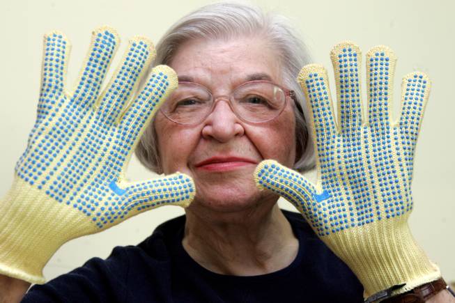Stephanie Kwolek, 83, shown in this June 20, 2007, file photo taken in Brandywine Hundred, Del., wears regular house gloves made with the Kevlar she invented. Her friend, Rita Vasta, told The Associated Press that Kwolek died Wednesday in a Wilmington hospital at age 90.