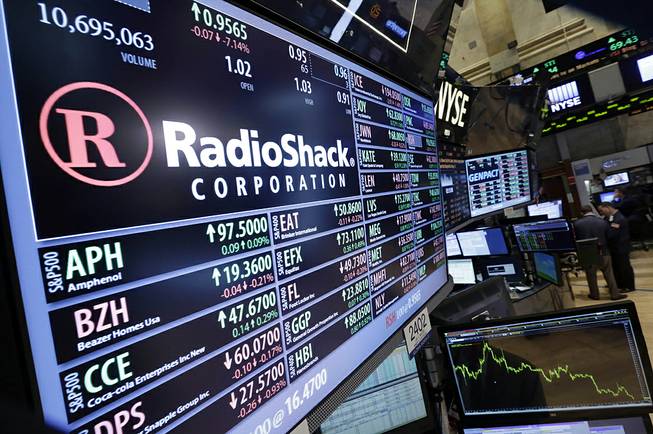 Traders work on the floor of the New York Stock Exchange near the post that handles Radio Shack, Friday, June 20, 2014. 