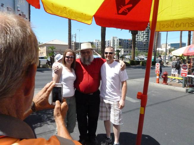 Mark Hall-Patton, center, poses for photos with fans outside the pawn shop featured on television's "Pawn Stars" in Las Vegas. Hall-Patton, the curator of the Clark County Museum, appears regularly on the show authenticating items brought into the shop.
