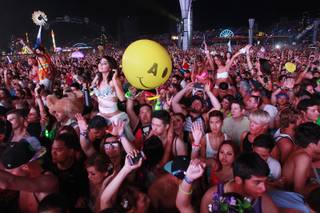 Attendees dance during the first night of the Electric Daisy Carnival early Saturday, June 21, 2014 at the Las Vegas Motor Speedway.