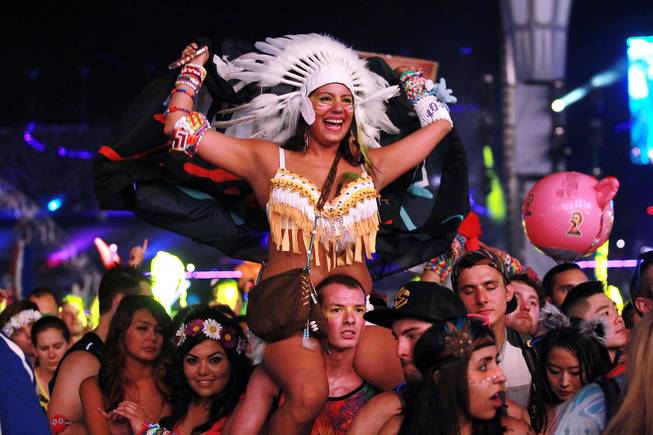 Attendees dance during the first night of the Electric Daisy Carnival early Saturday, June 21, 2014 at the Las Vegas Motor Speedway.