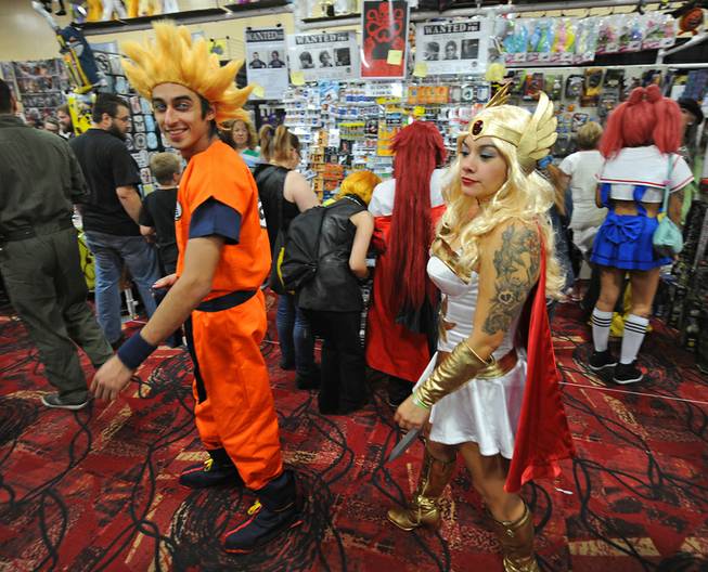 Costumed comic book fans browse booths while attending the first day of the Las Vegas Comic Con at the South Point Convention Center on Saturday, June 21, 2014.