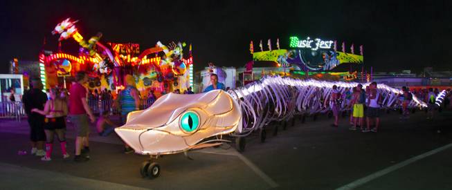 A giant, pedal-powered snake makes its way across the grounds during opening night of EDC at the Las Vegas Motor Speedway on Friday, June 20, 2014.