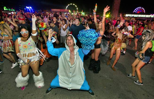 Revelers dance in front of the bassCON stage during opening night of EDC at the Las Vegas Motor Speedway on Friday, June 20, 2014.