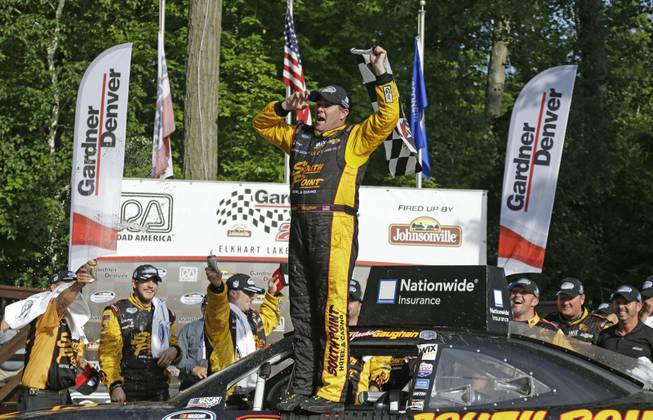 Brendan Gaughan celebrates after winning the NASCAR Nationwide series auto race at Road America in Elkhart Lake, Wis., on Saturday, June, 21, 2014.