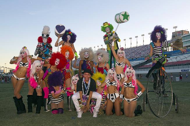 Steven Corona, center, of Hollywood, Calif. poses with performers "Team EZ" during the final day of the 2014 Electric Daisy Carnival (EDC) at the Las Vegas Motor Speedway Sunday, June 22, 2014.