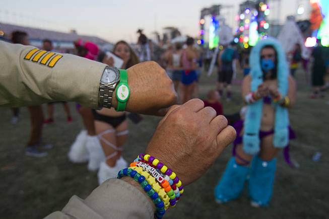 Metro Police Sgt. David Schofield shows off bracelets during the final day of the 2014 Electric Daisy Carnival (EDC) at the Las Vegas Motor Speedway Sunday, June 22, 2014.