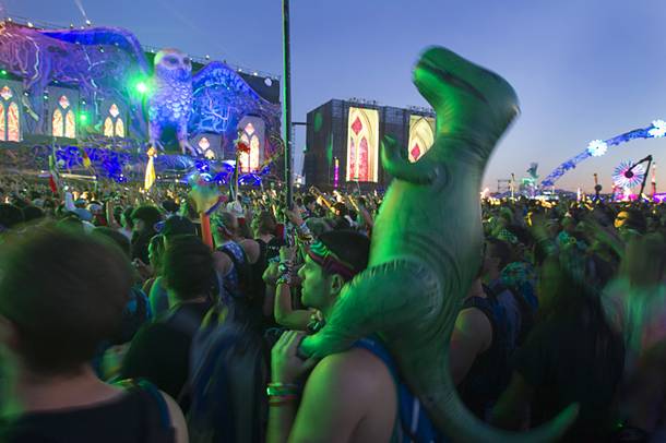 A man and his inflatable dinosaur are shown during the final day of the 2014 Electric Daisy Carnival (EDC) at the Las Vegas Motor Speedway Sunday, June 22, 2014.