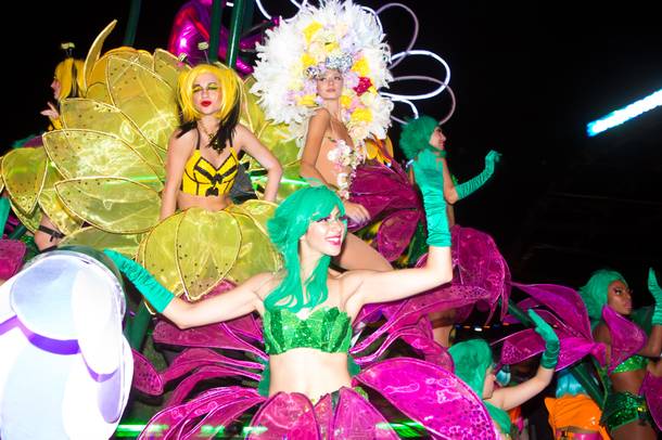 Performers ride through the crowd on a parade float during night 2 of EDC, Saturday June 21, 2014 at the Las Vegas Motor Speedway.