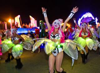 A costume parade takes to the grounds during the second night of EDC at the Las Vegas Motor Speedway on Saturday, June 21, 2014.