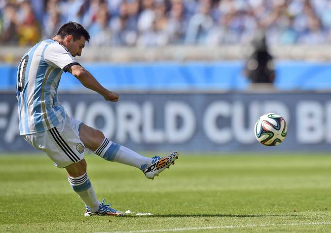 Argentina's Lionel Messi takes a free kick during the group F World Cup soccer match between Argentina and Iran at the Mineirao Stadium in Belo Horizonte, Brazil, Saturday, June 21, 2014.