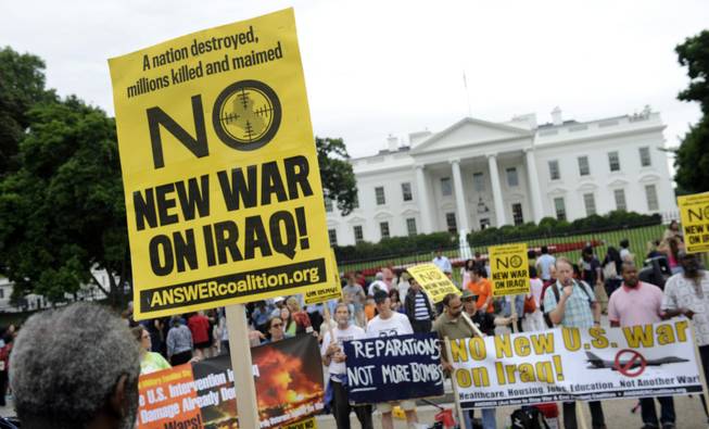 This photo taken Saturday, June 21, 2014, shows demonstrators protesting outside of the White House in Washington against renewed U.S. involvement in Iraq. In charting a new phase of American military engagement in Iraq on Thursday, President Barack Obama pledged that his war-weary country will not be "dragged back" into a lengthy conflict or become ensnarled in "mission creep." But recent U.S. military history is full of warning signs about the difficulty of keeping even a limited mission from expanding and extending.