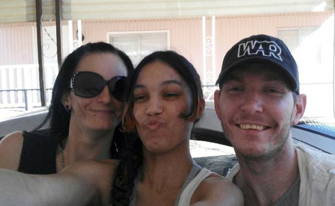 This undated image provided courtesy of Jeremy Tanner shows Las Vegas shooting victim Joseph Wilcox, right, along with his sisters Angel Wilcox, left, and C.J. Foster. Wilcox died June 8, 2014, after trying to confront an armed gunman inside a Las Vegas Wal-Mart.
