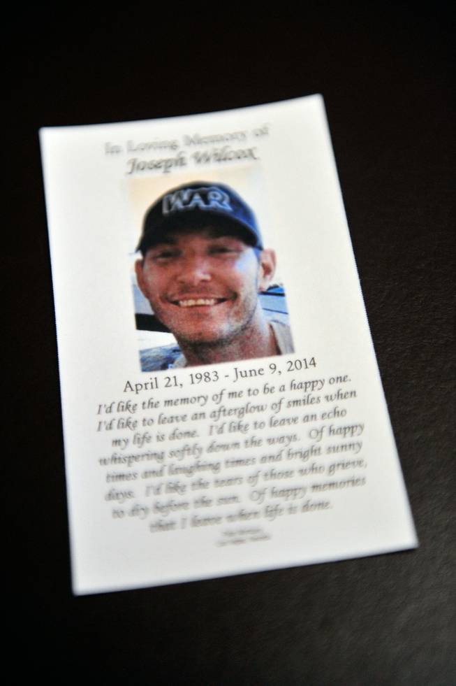A mass card is displayed during a memorial service for Joseph Wilcox at Palm Downtown Mortuary and Cemetery on Sunday, June 22, 2014. Wilcox, 31, was killed trying to stop Jerad and Amanda Miller in the midst of their shooting spree at an east valley Walmart store on June 8.