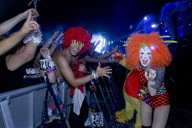 A "Team EZ" performer is shown with a fan during the final night of the 2014 Electric Daisy Carnival (EDC) at the Las Vegas Motor Speedway Sunday, June 22, 2014.