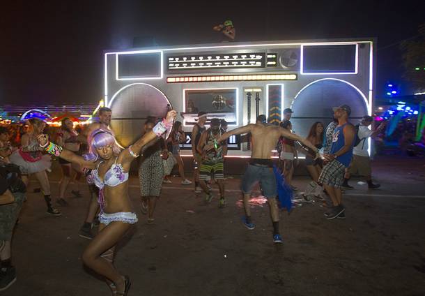 Attendees dance in front of a mock-up of a giant boom box during the final night of the 2014 Electric Daisy Carnival (EDC) at the Las Vegas Motor Speedway Sunday, June 22, 2014.
