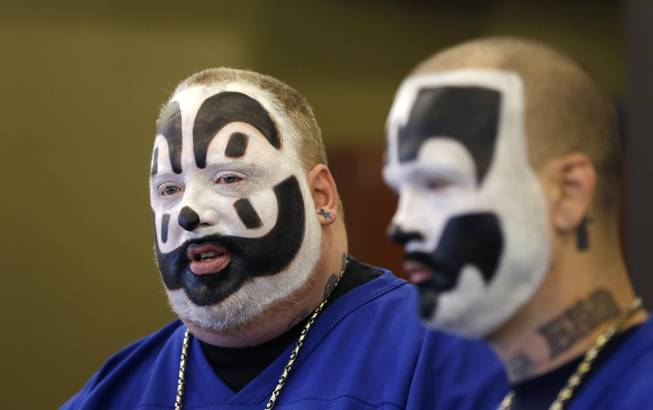 In this Jan. 8, 2014, photo, Joseph Bruce, aka Violent J, left, and Joseph Utsler, aka Shaggy 2 Dope, members of the Insane Clown Posse, address the media in Detroit. The U.S. Justice Department is asking a judge to dismiss a lawsuit by Insane Clown Posse, which objects to a report that describes its fans as a dangerous gang.