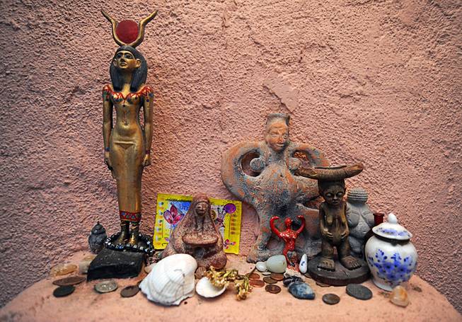 Figurines representing female deities of various cultures and religions adorn a small shelf inside the Temple of Goddess Spirituality dedicated to Sekhmet, a small temple located in the desert outskirts of Indian Springs.